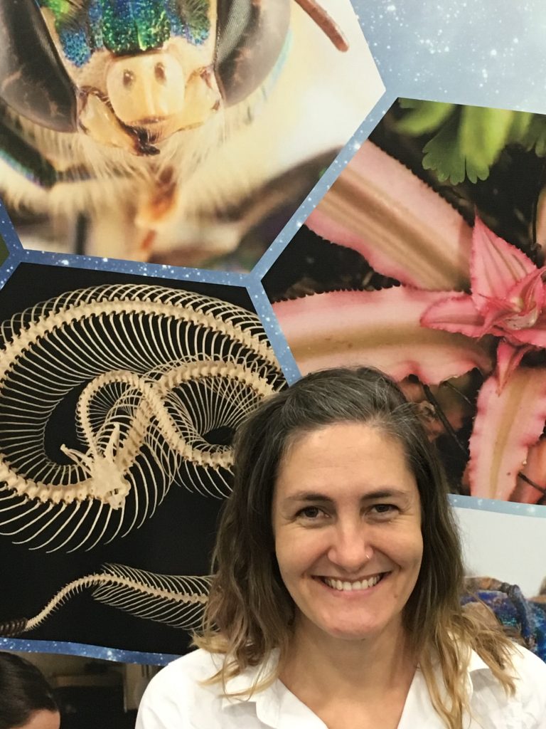 woman standing in front of photos of animals
