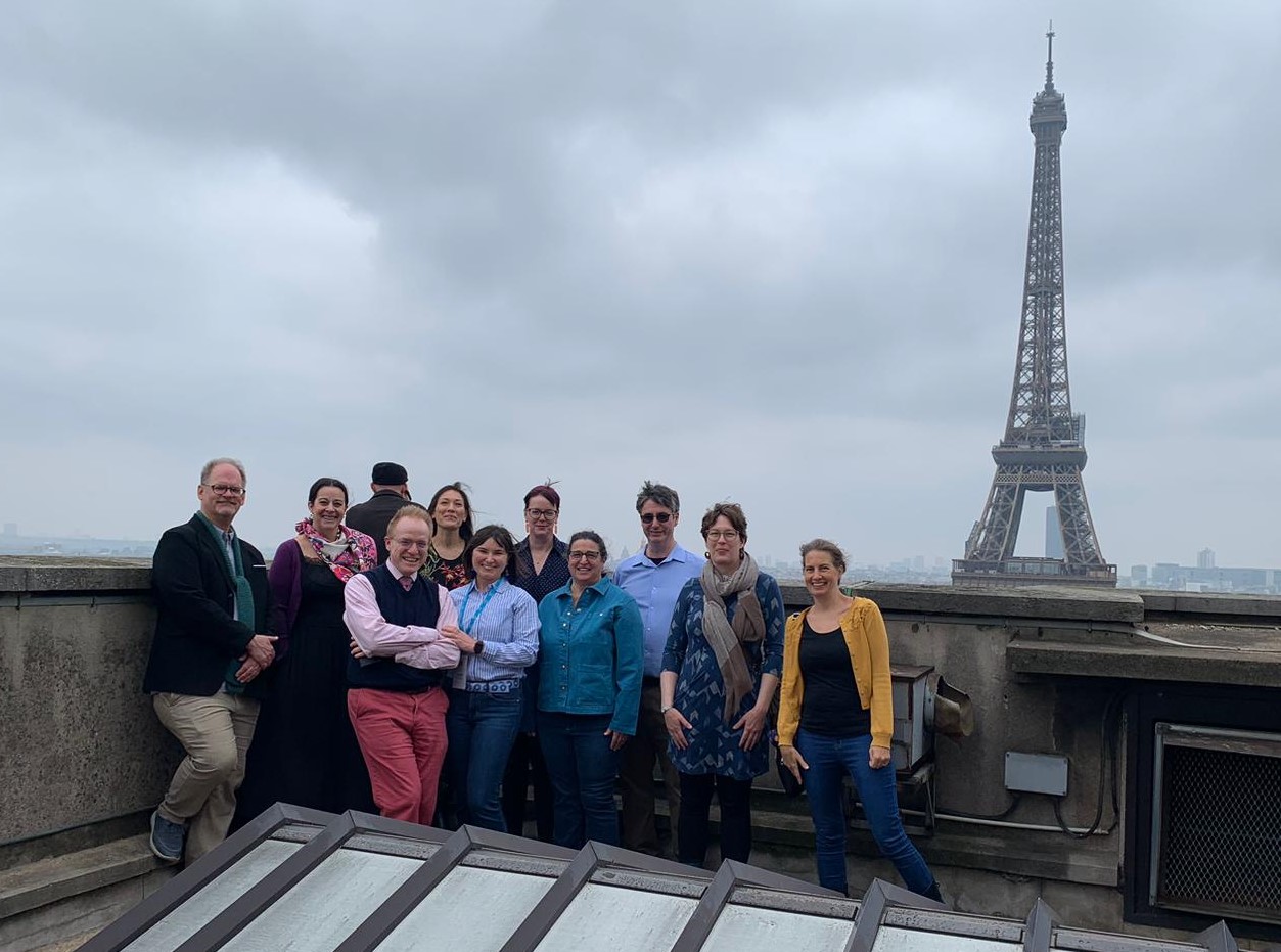 BHL meeting attendees pose for a picture on the rooftop of the Musee de l'Homme with the Eiffel Tower in the background