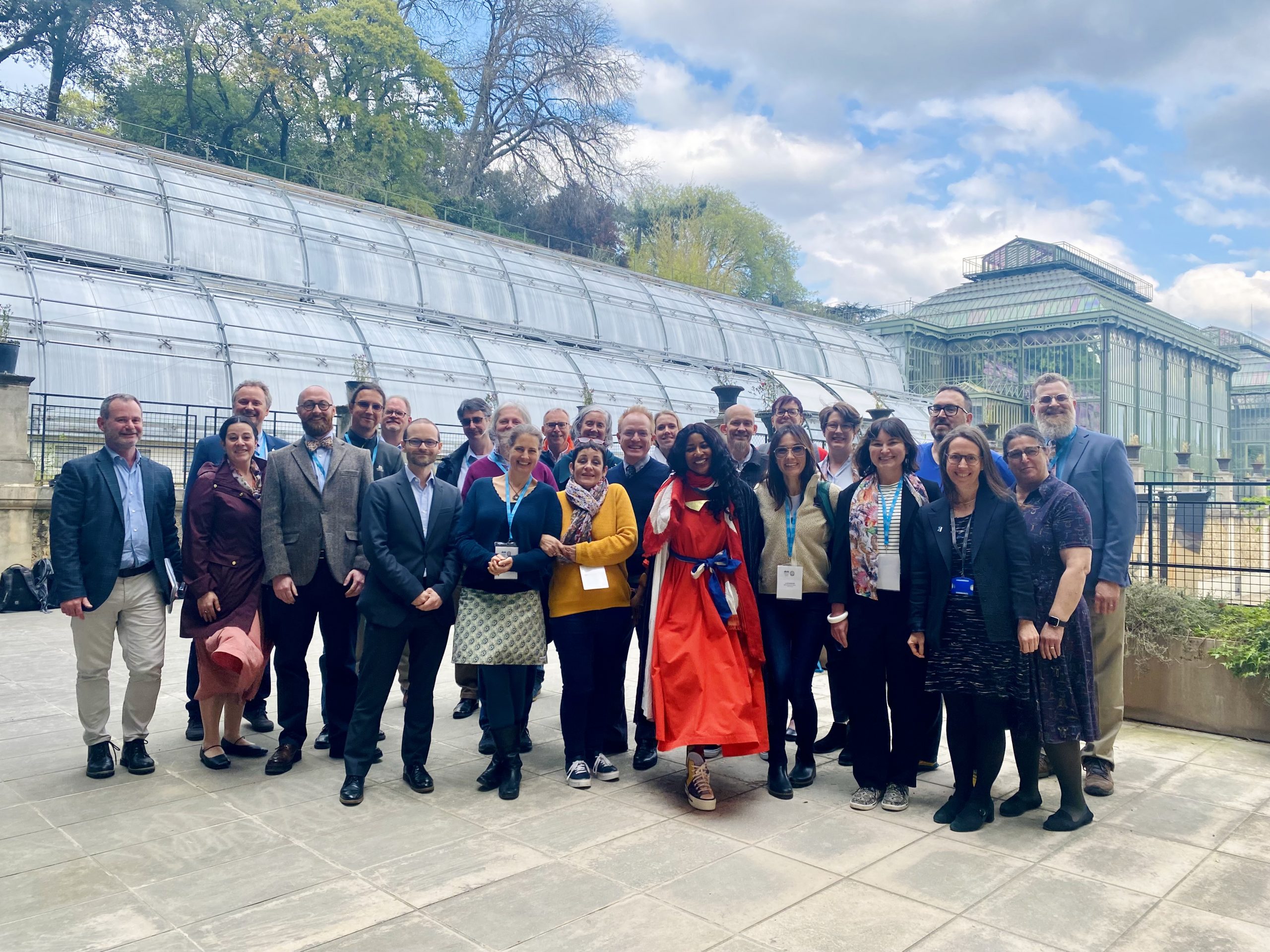 Attendees of the Biodiversity Heritage Library annual meeting pose for a group photo in front of the greenhouses in Jardin des Plantes