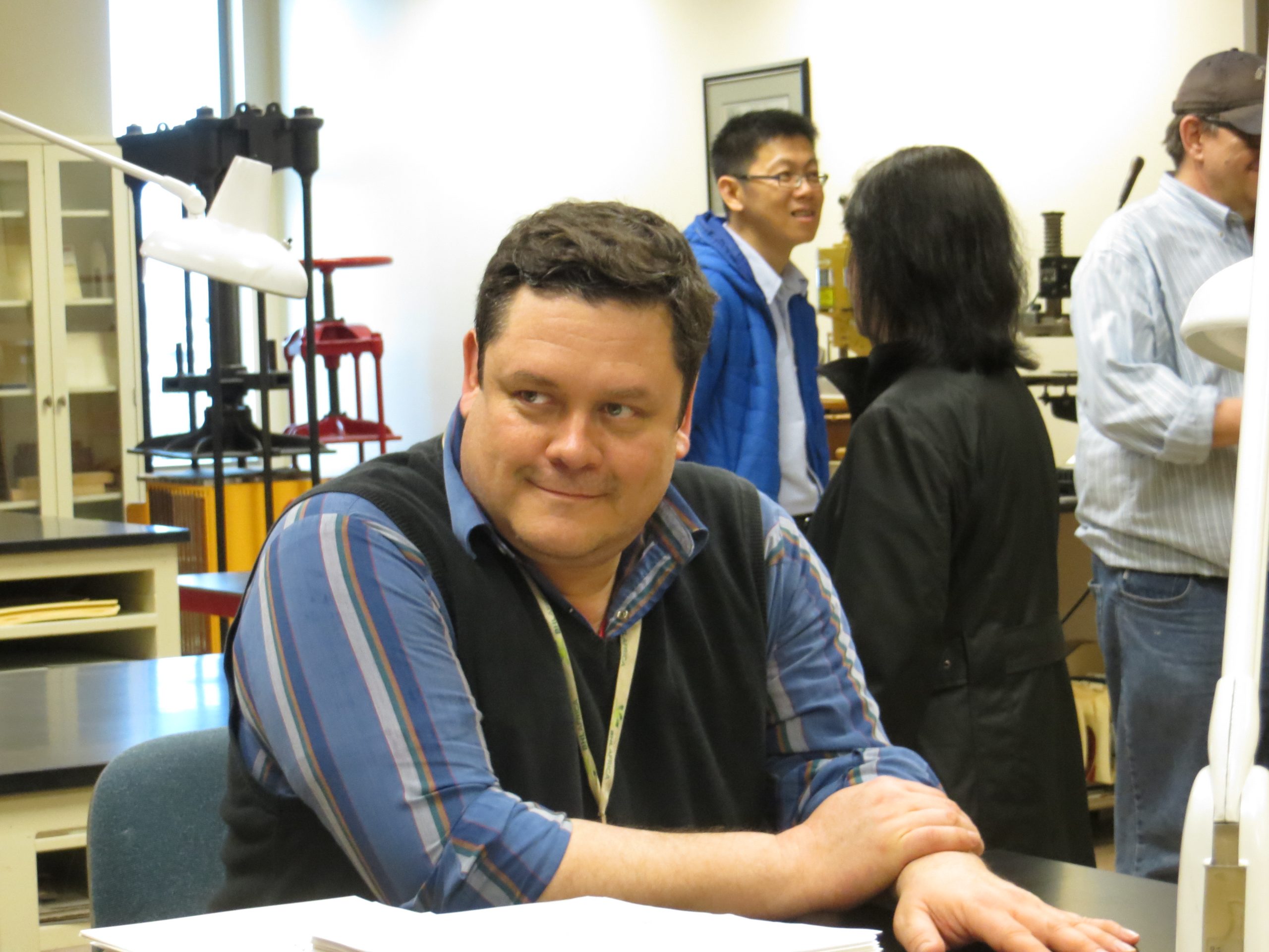 William Ulate Rodriguez sits at a table, smiling.