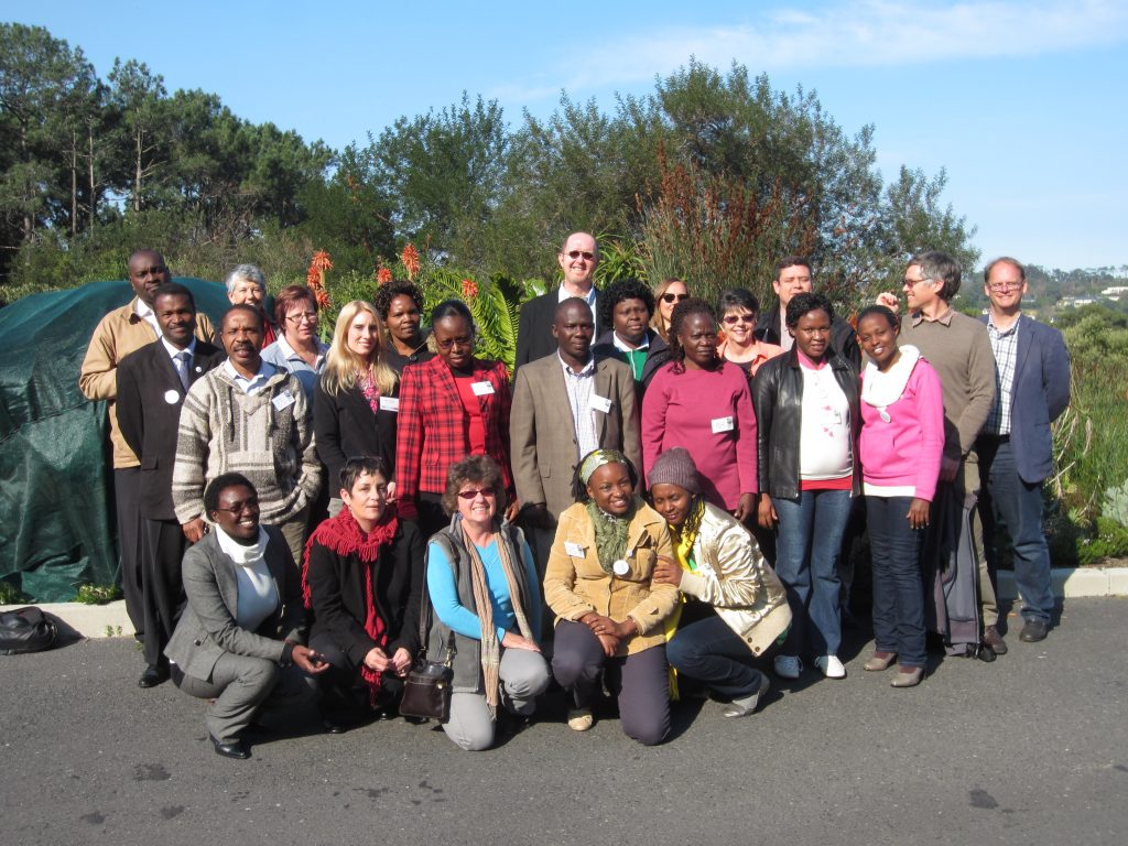 Nancy Gwinn and BHL Africa meeting attendees stand outside for a group photo