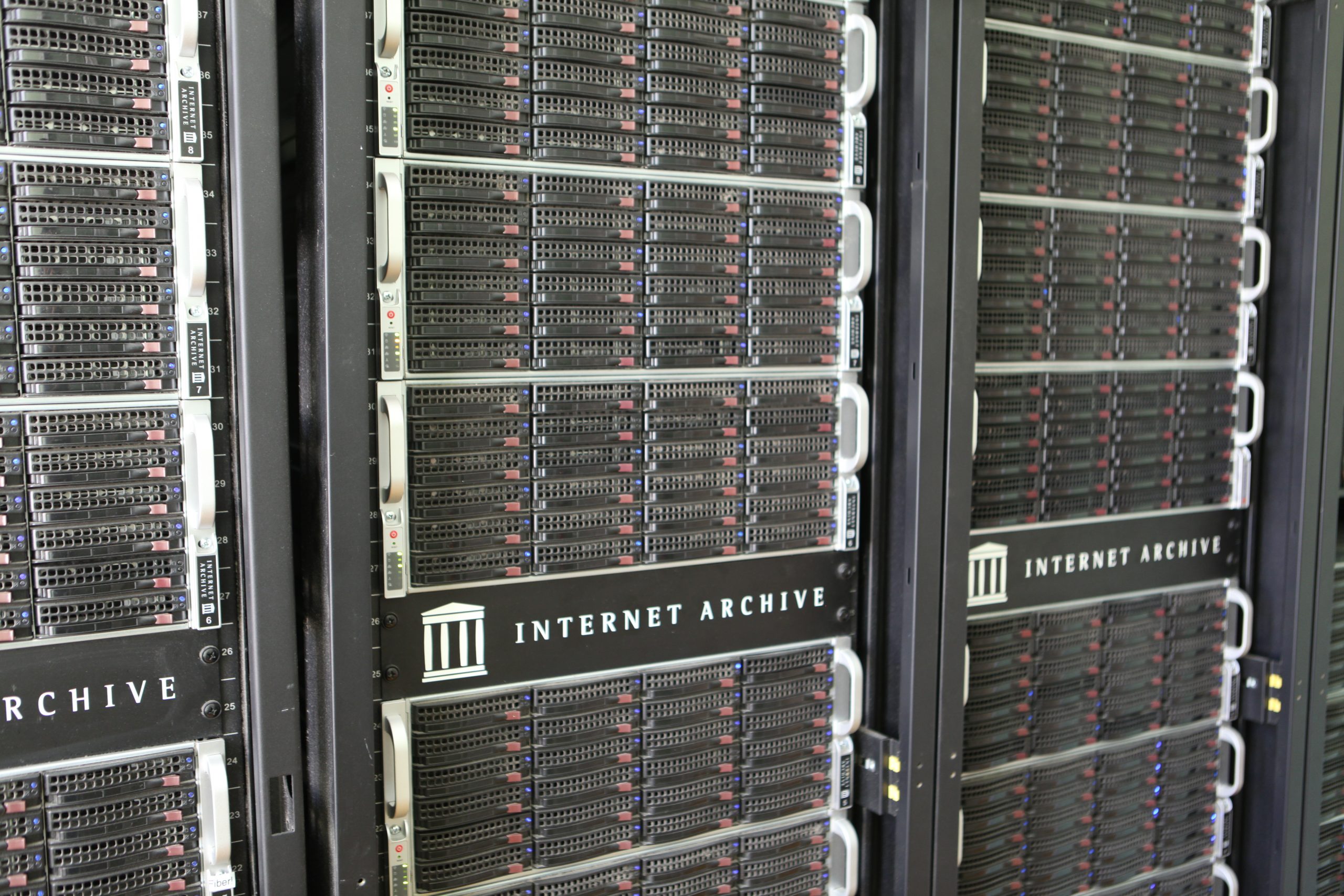 Three racks of servers labeled with Internet Archive name and logo