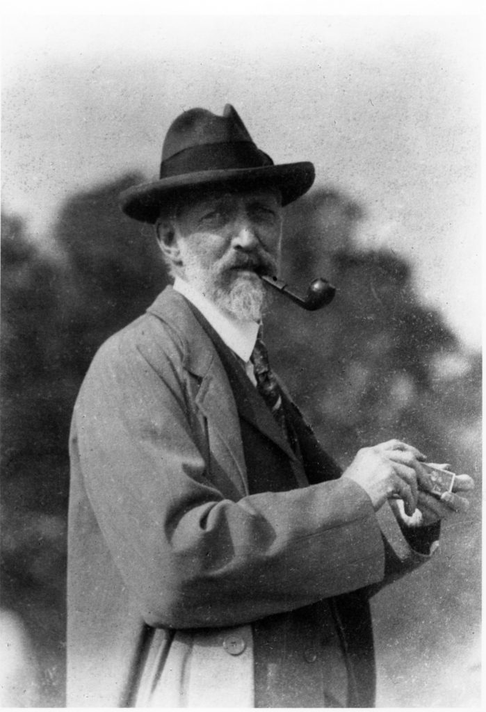 photo of a man smoking a pipe outside