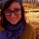 picture of a woman in a knitted hat standing outside in fall