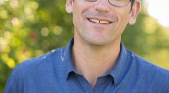 Caucasian male in a blue shirt