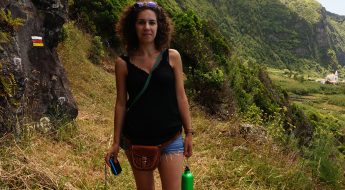 image of a woman standing next to a mountain