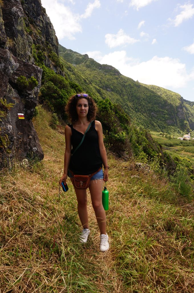 image of a woman standing next to a mountain