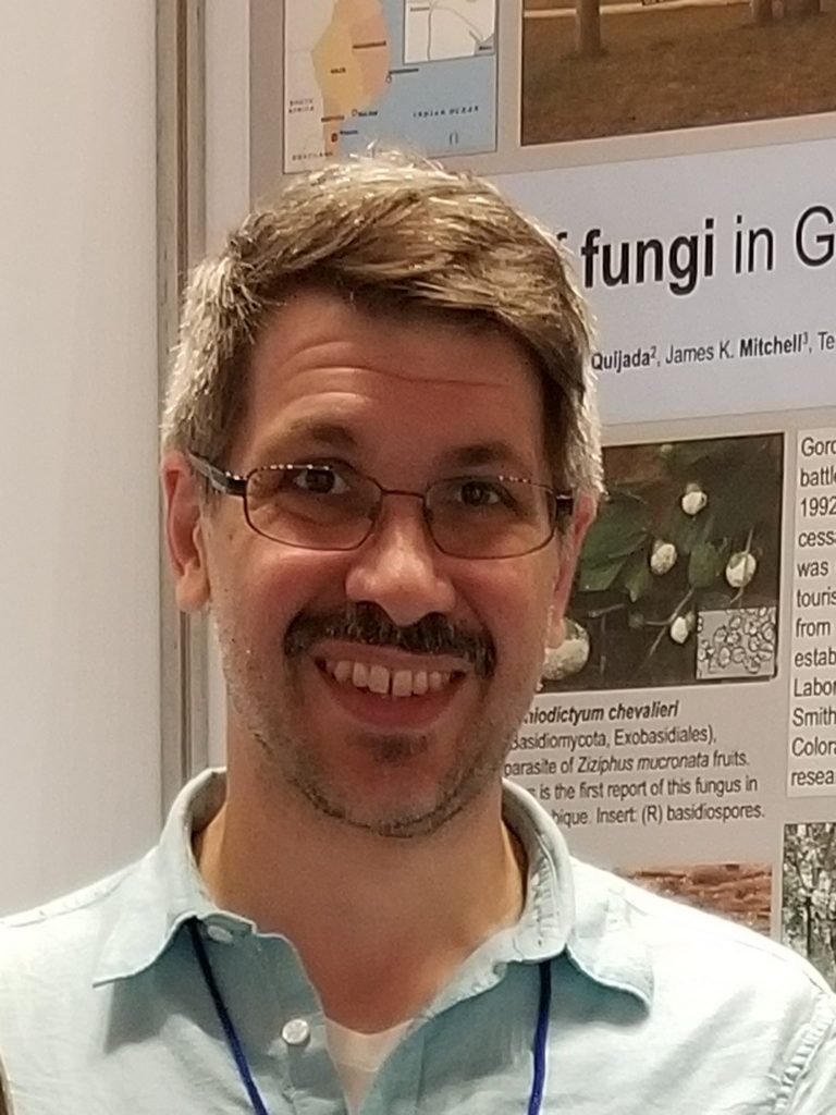 photo of a man in glasses and blue shirt