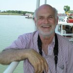 white male standing before water