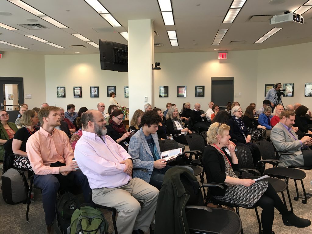 Room full of people sitting.