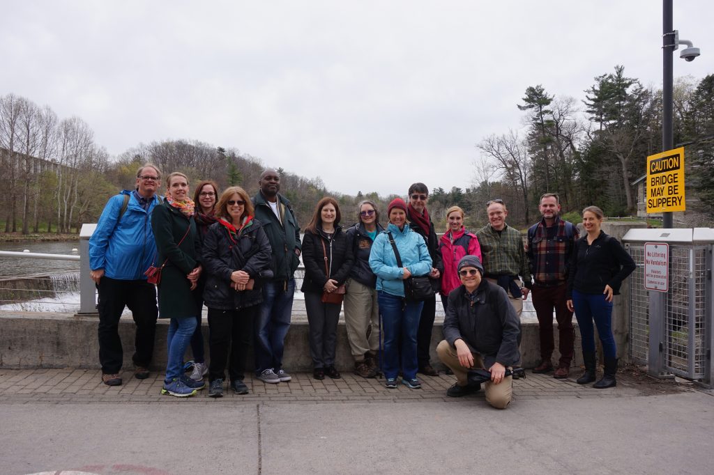 Group of people standing on a bridge.