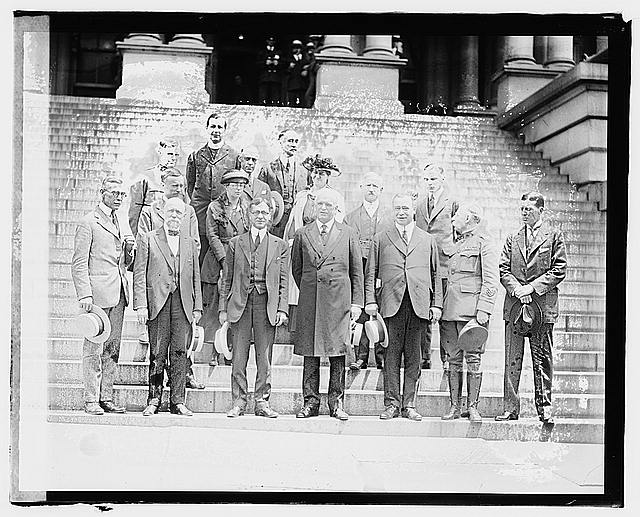 Black and white photograph of a group of men standing on steps.