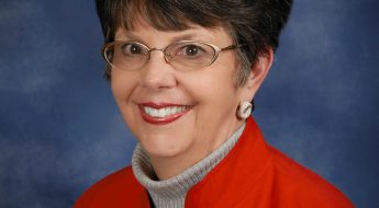 photo of a dark haired person in a red jacket