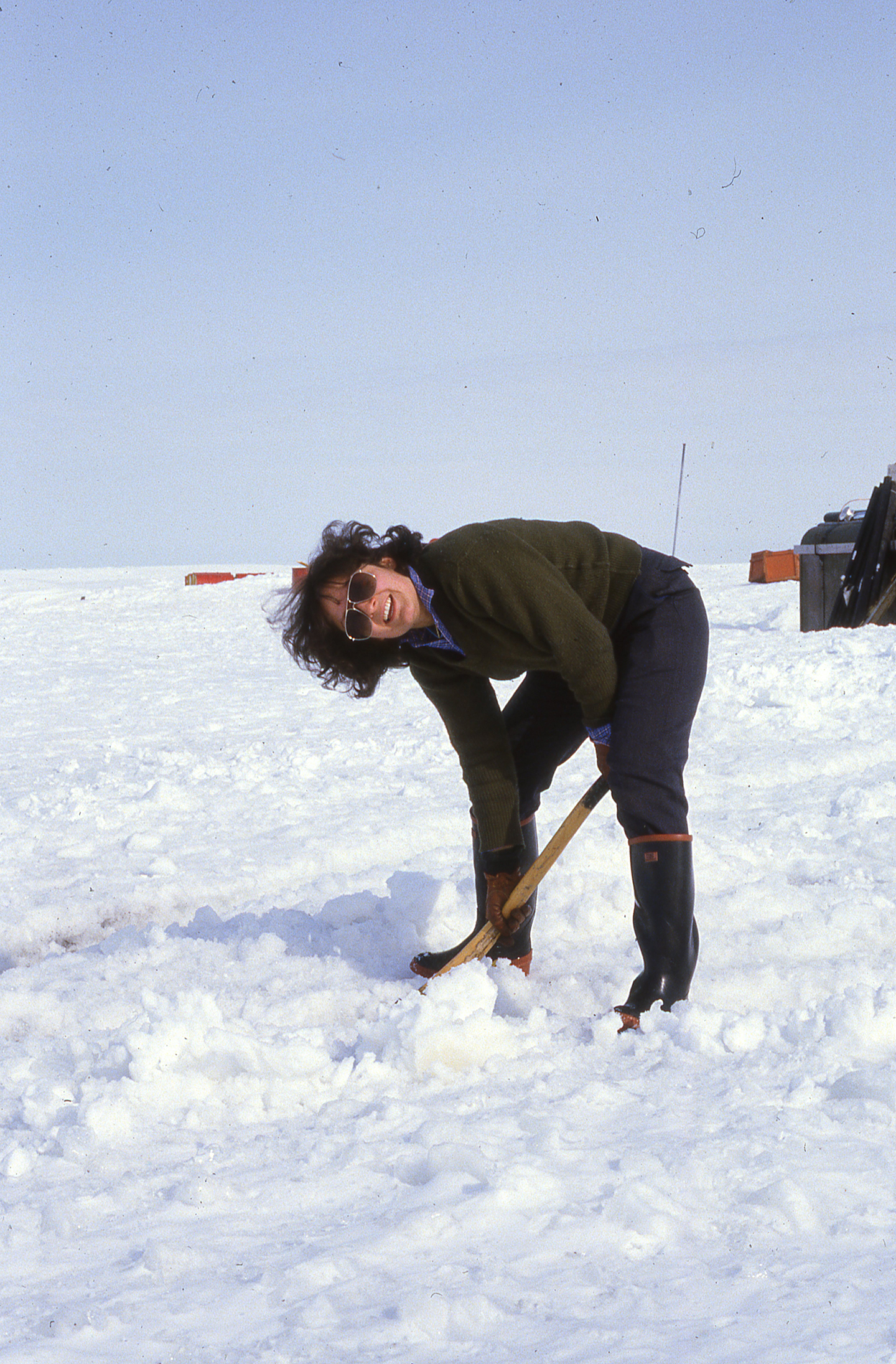 Woman in a black jacket standing in snow
