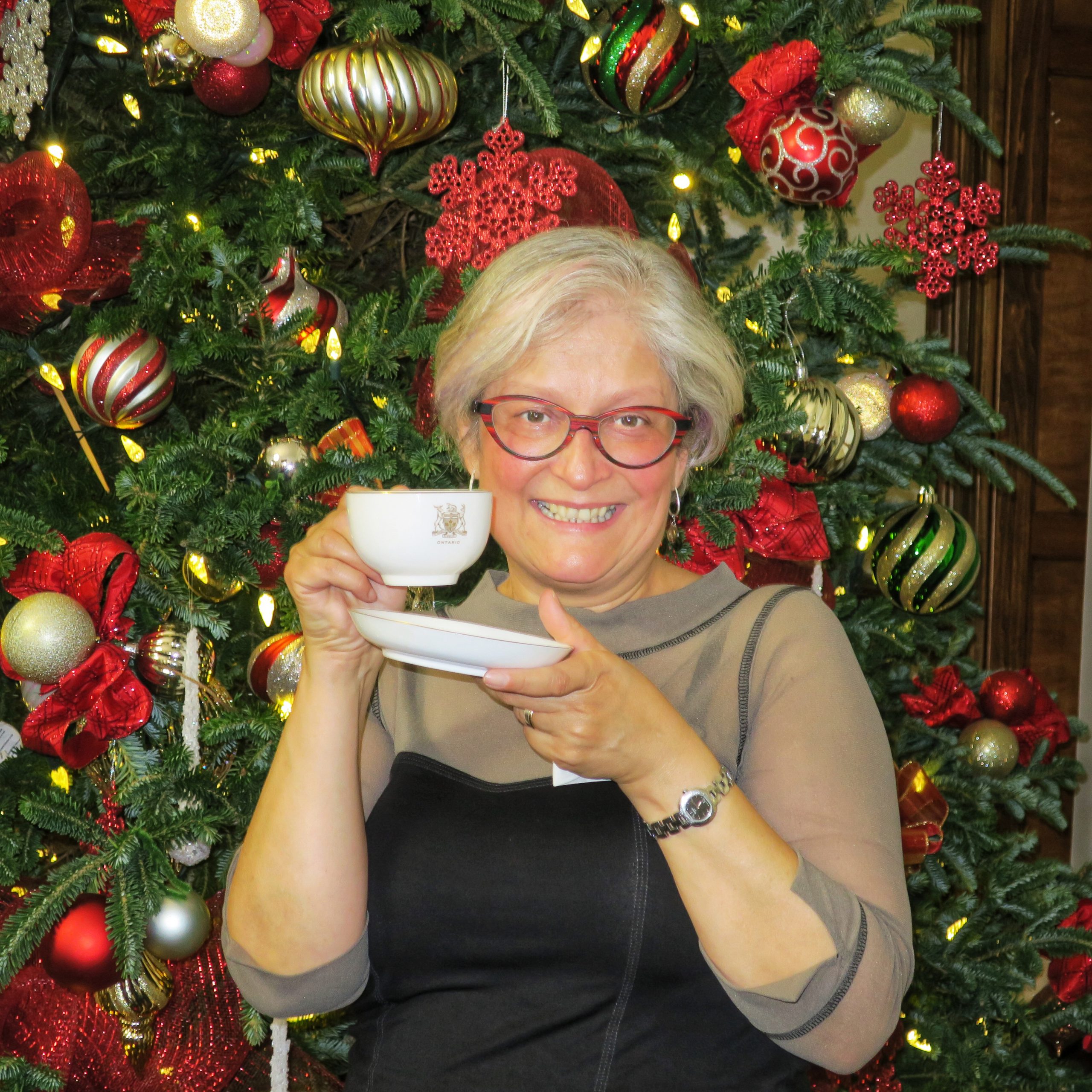 woman standing in front of a christmas tree