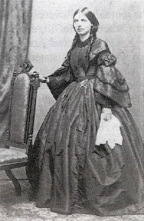 Black and white photo of a brunette person in a dress
