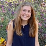 woman sitting in a field of flowers
