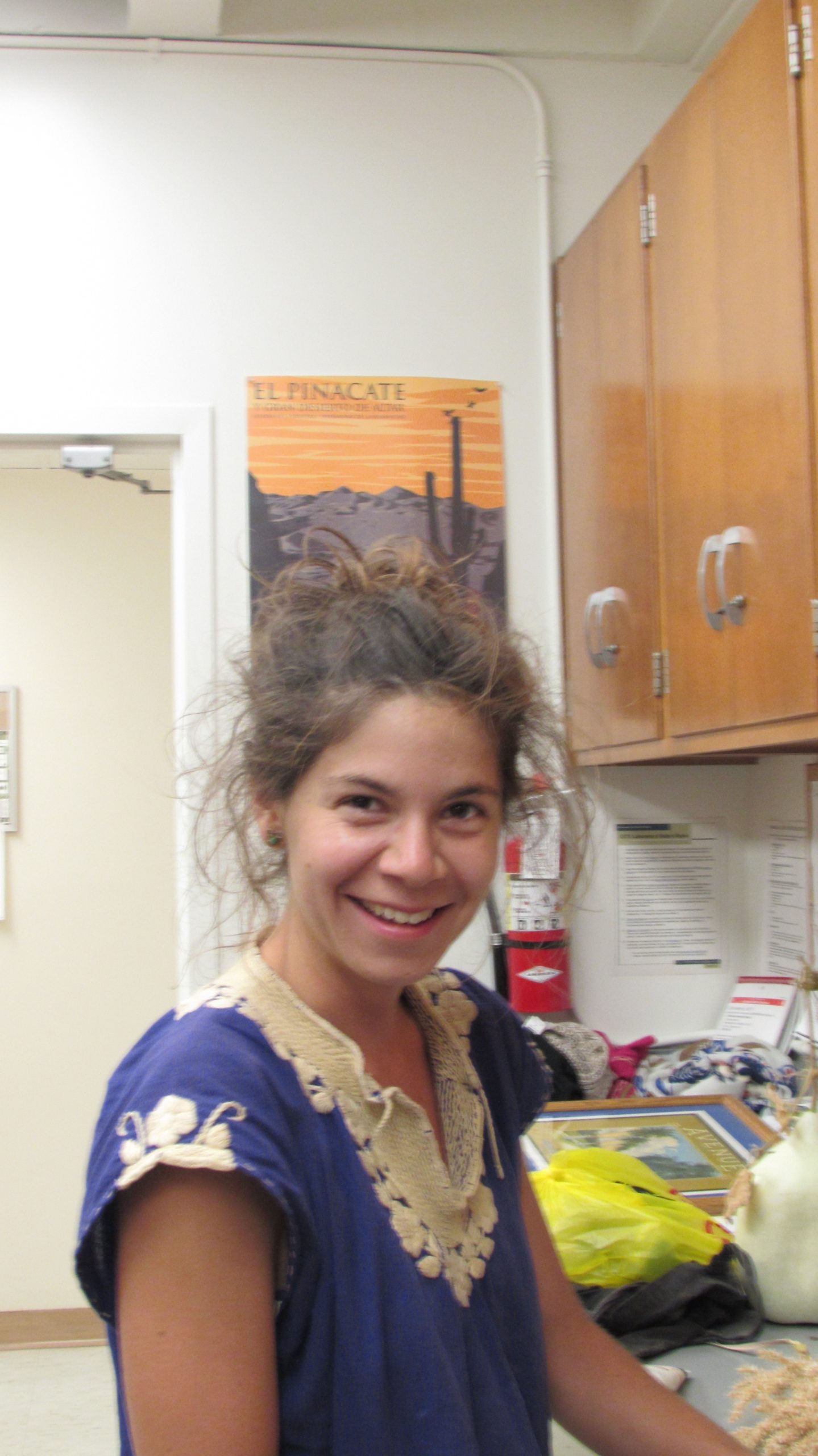woman with brown hair and purple shirt in a lab