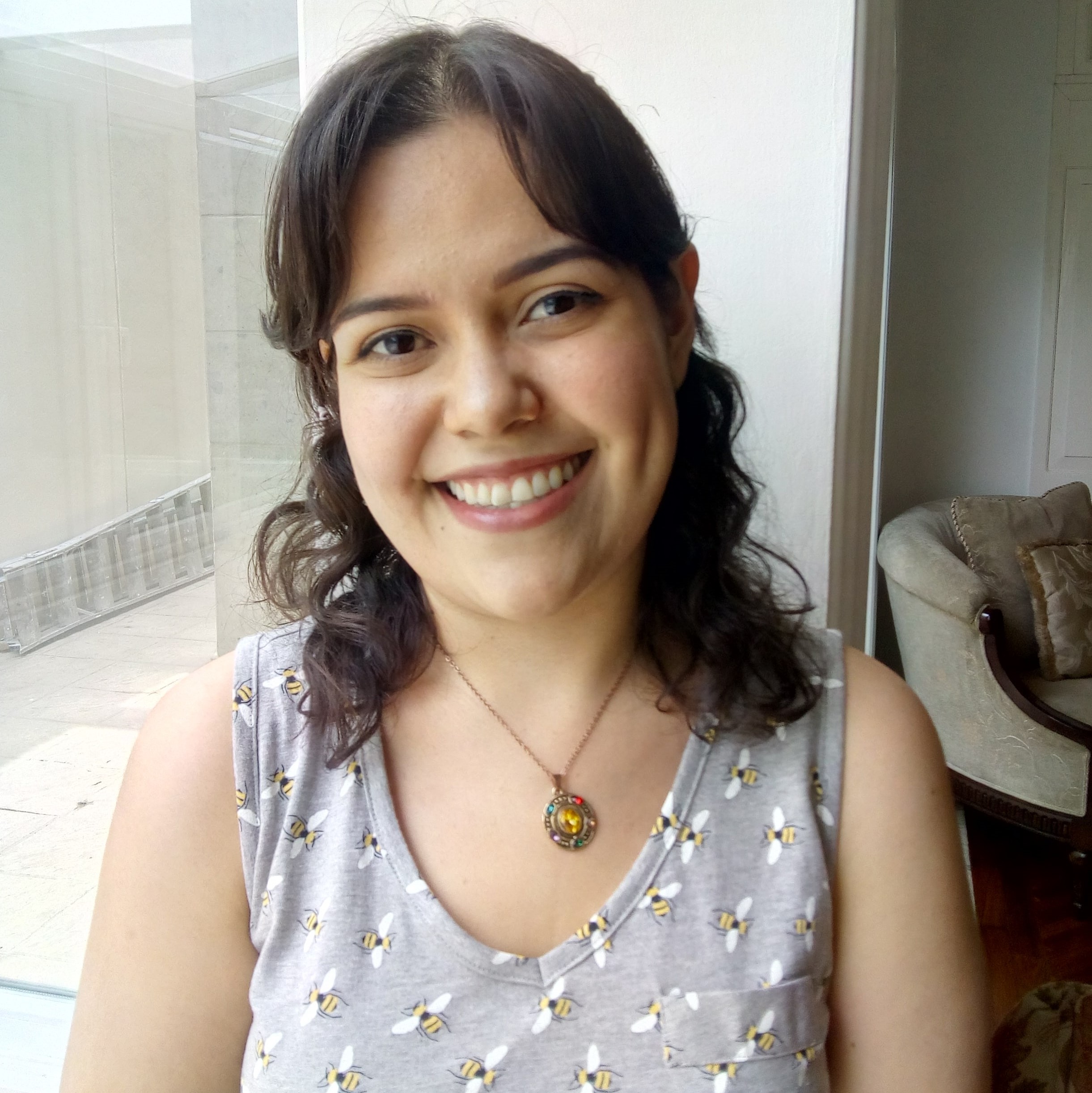 photo of a woman in a pale purple shirt with dark hair