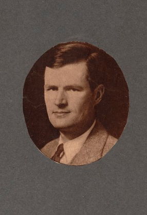 Black and white portrait of a man in a suit and tie.