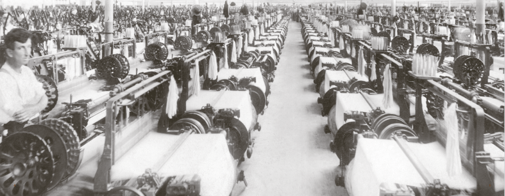 black and white photo of a textile mill weave room.