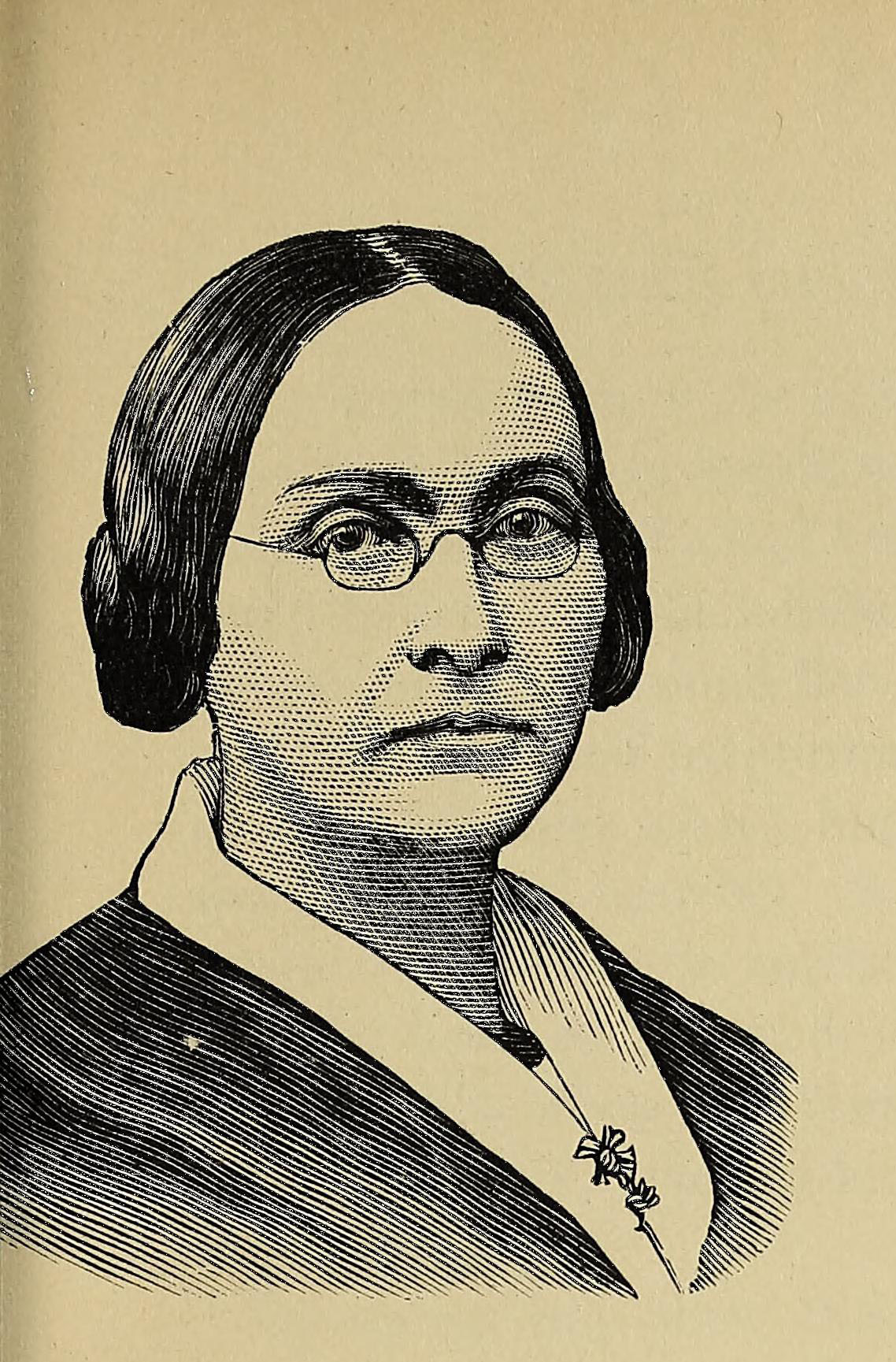 Black and white portrait of a person wearing glasses.