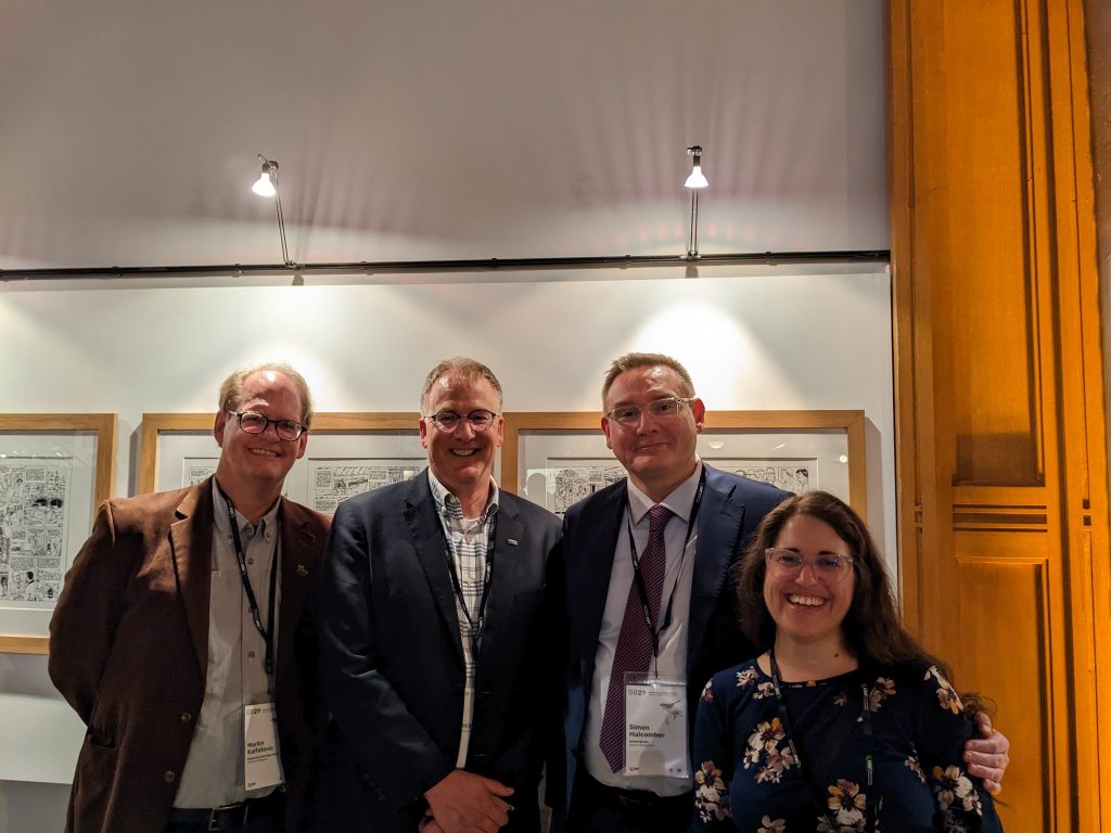 Martin Kalfatovic, Joe Miller, Simon Malcomber, and Abby Benson smile for a group photo
