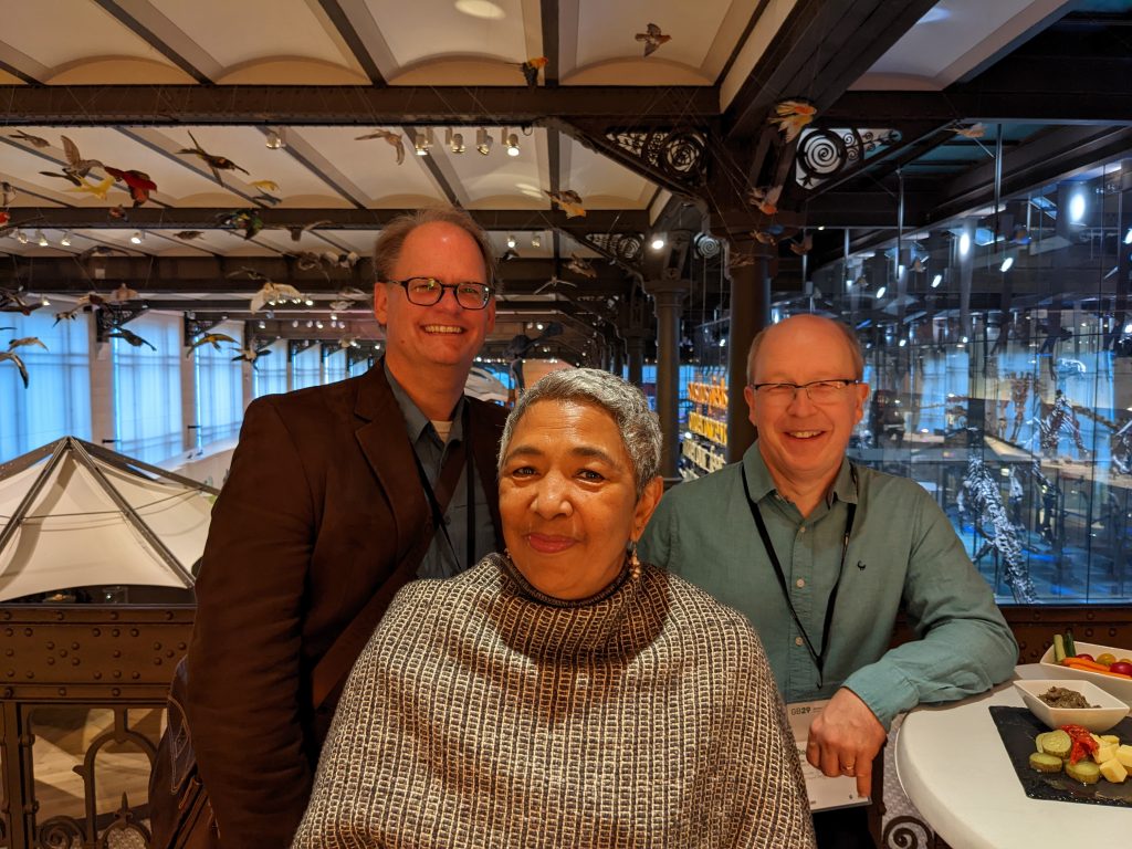 Martin Kalfatovic, Tanya Abrahamse and Donald Hobern smile for a group photo during dinner in the Dinosaur Gallery