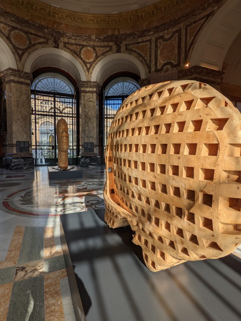 Interior view of the grand rotunda with two wooden sculptures facing each other