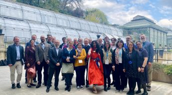 Attendees of the Biodiversity Heritage Library annual meeting pose for a group photo in front of the greenhouses in Jardin des Plantes