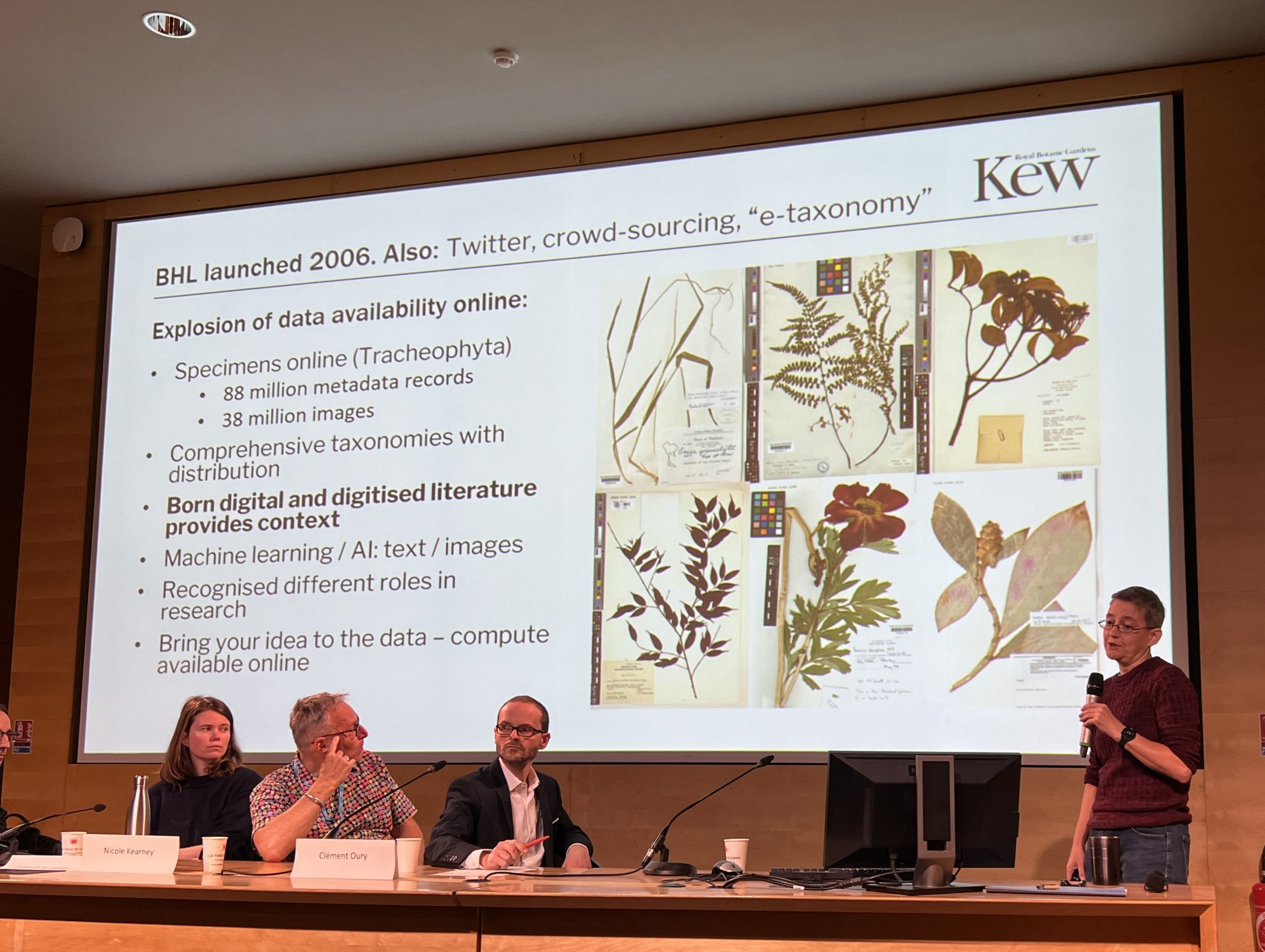 A panel of speakers on stage as Nicky Nicolson presents