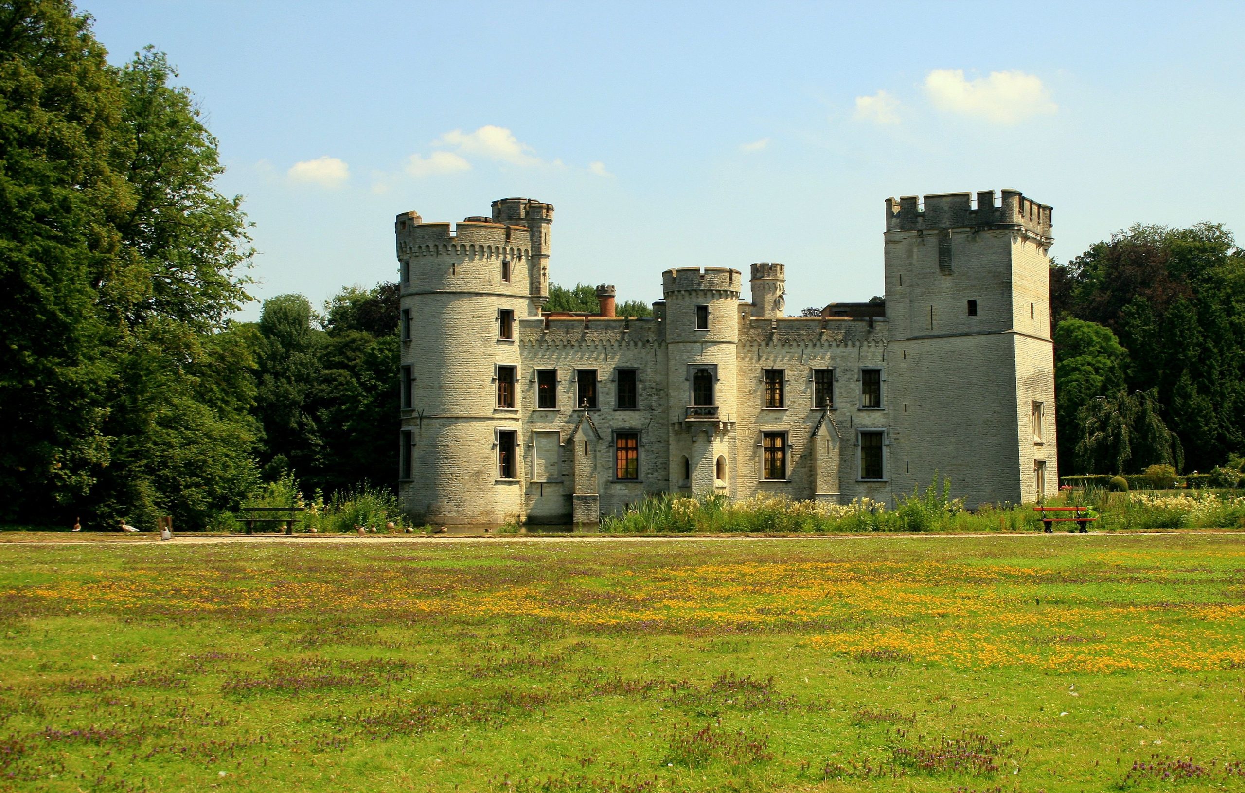 Bouchout Castle surrounded by trees and meadow at Meise Botanic Garden