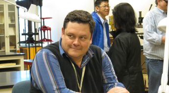 William Ulate Rodriguez sits at a table, smiling.